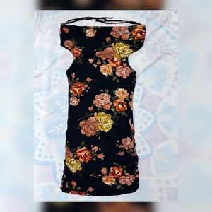 Floral design. A bodycon dress. Scrunches on both sides. Fall off the shoulder.